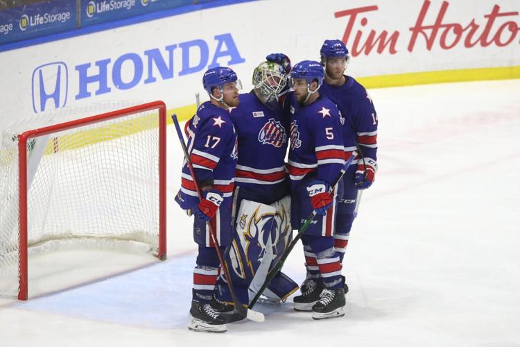 Rochester Amerks support their goalie