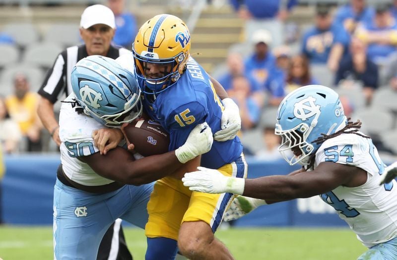 Oct 10, 2026; Pittsburgh, Pennsylvania, USA;  North Carolina Tar Heels defensive lineman Xavier Lewis (90)  and linebacker Timir Hickman-Collins (54) sack Pittsburgh Panthers quarterback Holden Geriner (15) during the second quarter at Acrisure Stadium....