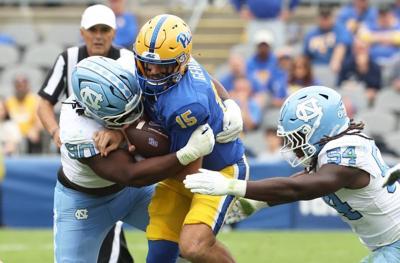 Oct 10, 2026; Pittsburgh, Pennsylvania, USA;  North Carolina Tar Heels defensive lineman Xavier Lewis (90)  and linebacker Timir Hickman-Collins (54) sack Pittsburgh Panthers quarterback Holden Geriner (15) during the second quarter at Acrisure Stadium....