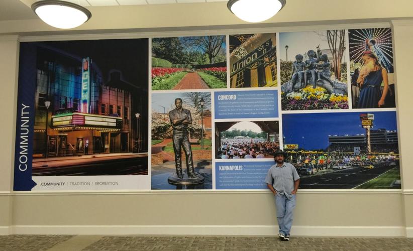 Michael Anderson in front of community photos