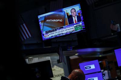 A screen displays news about Anthropic's IPO on the floor of the New York Stock Exchange (NYSE) in New York City