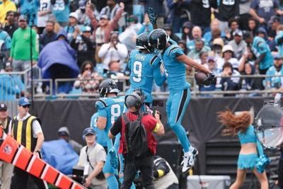 Oct 12, 2025; Charlotte, North Carolina, USA; Carolina Panthers wide receiver Tetairoa McMillan (4) celebrates a touchdown with quarterback Bryce Young (9) during the second quarter against the Dallas Cowboys at Bank of America Stadium. Mandatory Credit...