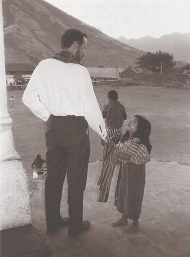 In the most popular image of the Rev. Stanley Rother, the priest is seen greeting a young girl in his beloved mission parish in Santiago Atitlan, Guatemala.