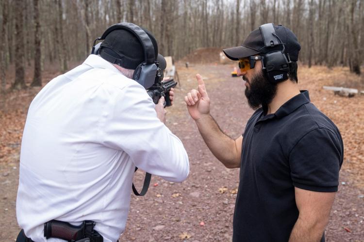 Raziel Cohen, right, firearms instructor, gives tips to Chaim Nieman while shooting an AR-15 rifle at a private gun range on Sunday, March 22, 2026, in Pennsylvania.