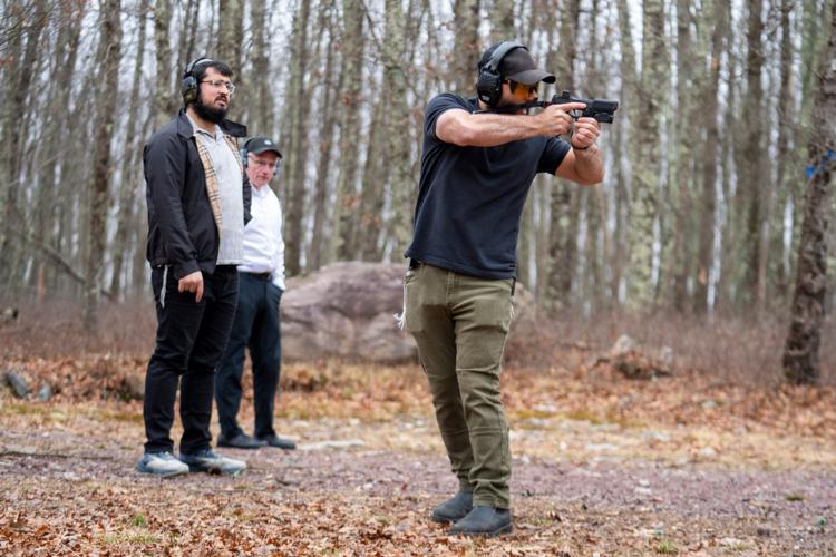 Raziel Cohen, also known as “The Tactical Rabbi” teaches step movements to clients Zalmy Cohen, left, and Chaim Nieman at a private gun range on Sunday, March 22, 2026, in Pennsylvania.