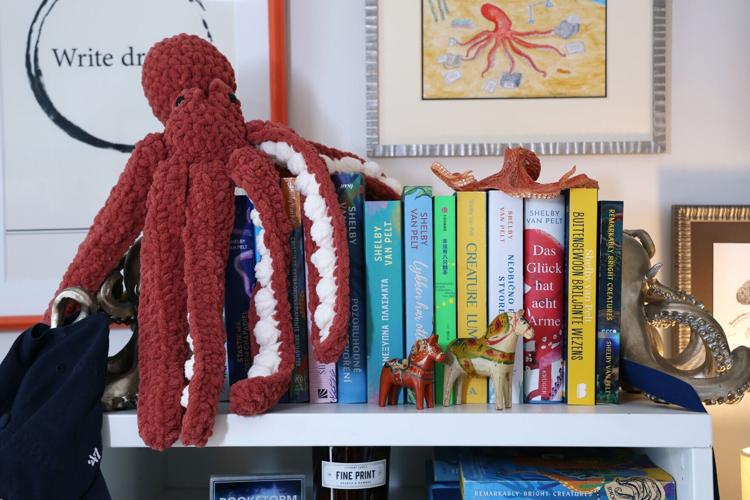 Foreign language copies of the book "Remarkably Bright Creatures" are on display along with renderings of octopuses in the home office of its author Shelby Van Pelt in Wheaton, IL, on Thursday, April 23, 2026.
