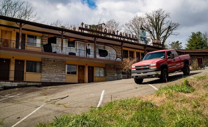 A pickup truck drives along the sloped lot at the Mountaineer Inn on Tunnel Road on March 23, 2026, in Asheville, North Carolina.