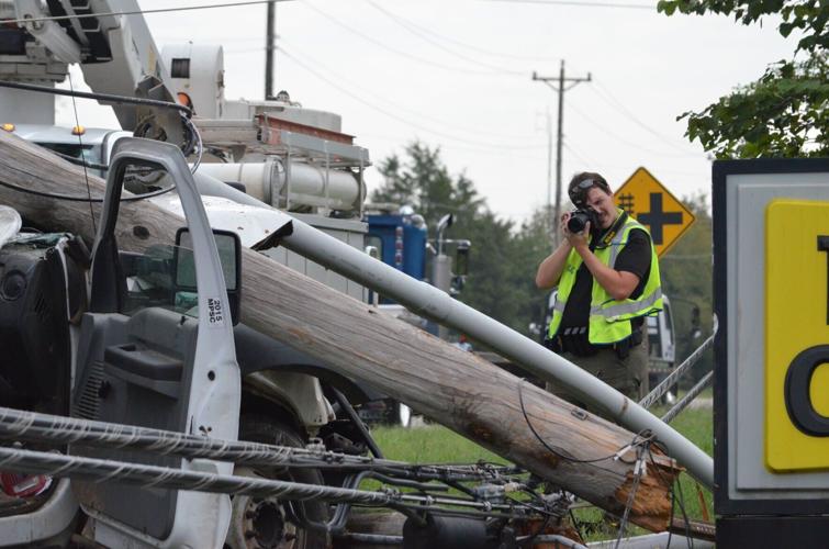 Officer Andrew Mason of the Statesville Police's Traffic Unit investigates the scene of a collision on US Highway 70 in Statesville on Wednesday.