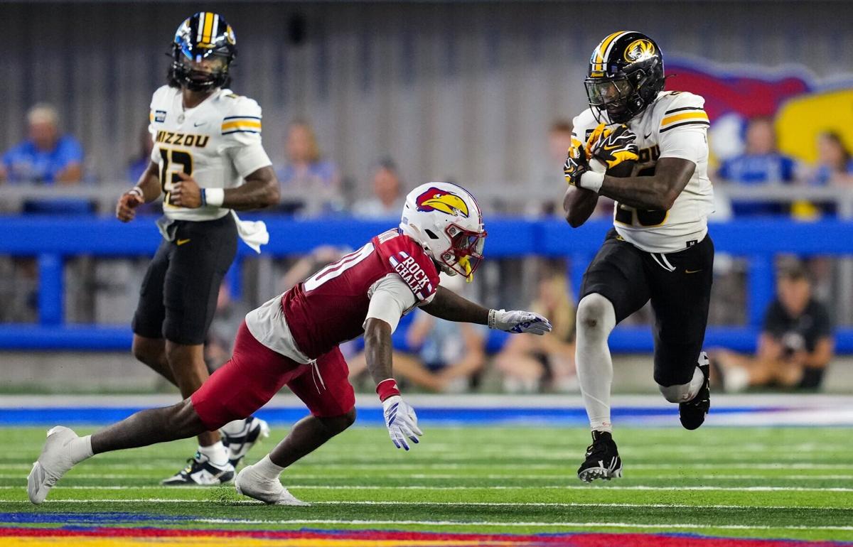 Missouri running back Jamal Roberts carries the ball as Kansas cornerback Elijah Cannon looks to make a tackle during the second half at David Booth Kansas Memorial Stadium on Friday, Sept. 11, 2026, in Lawrence, Kansas.