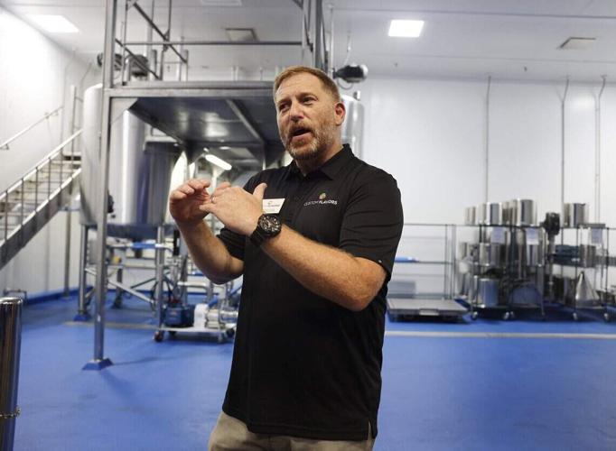 Matt Pulskamp, chief operating officer of Custom Flavors explains the equipment used to make various flavors on Thursday, June 11, 2026 at the grand opening of the new east coast facility in Concord.