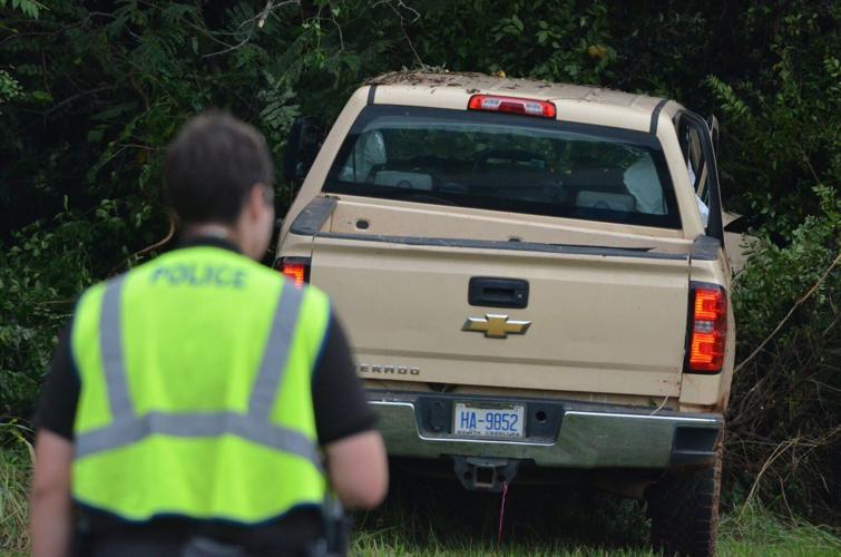A pickup truck came to a stop in the treeline along US Highway 70 in Statesville after a collision on Wednesday.