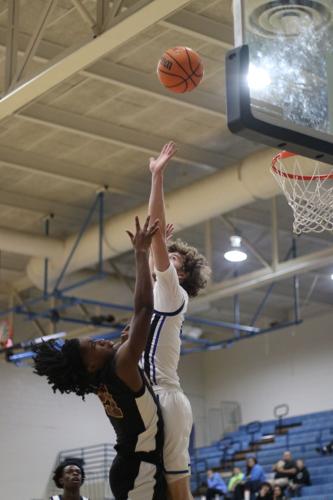 Noah Speller Shoots Over the Blue Devil Defender