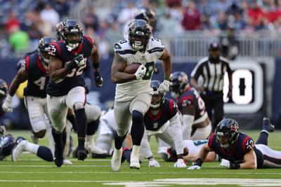 Seattle Seahawks running back Rashaad Penny breaks off a 47- yard touchdown run during the fourth quarter against the Houston Texans at NRG Stadium on Dec. 12, 2021, in Houston.