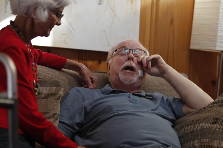 Ron Barber, in pain from gunshot wounds, is consoled by his wife, Nancy, at his home in Tucson two weeks after the shooting in which he and U.S. Rep. Gabrielle Giffords were injured.