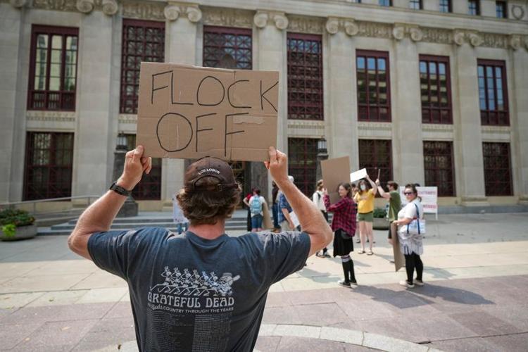 Anti-Flock surveillance protesters gather outside Columbus City Hall before a council hearing on the city's Flock Safety license plate-reading cameras on Aug. 10, 2026.