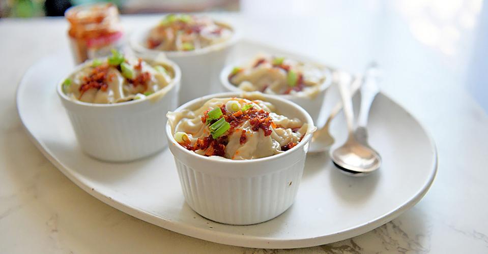 Dumpling lasagna is made with wonton wrappers and seasoned pork instead of pasta, cheese and red sauce.