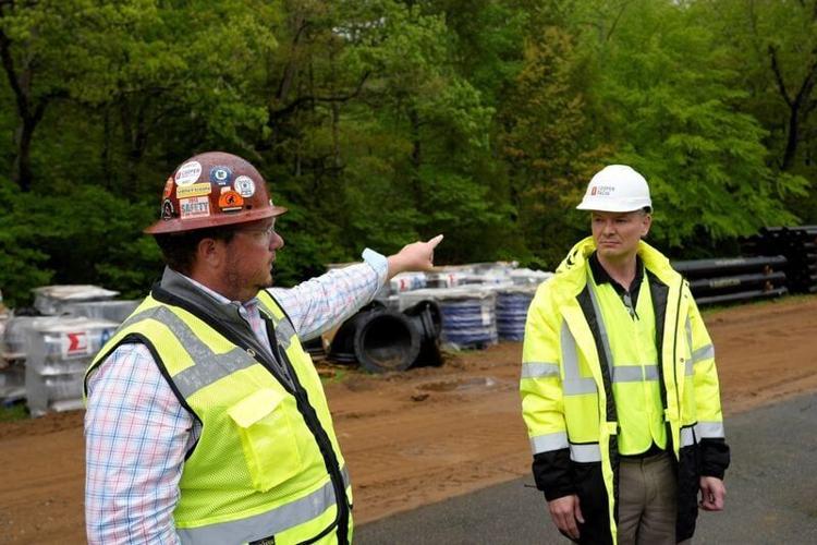 Cooper Tacia Senior Project Manager Cameron Jones, left, with President and CEO John Cooper at the Bobby N. Setzer State Fish Hatchery in Pisgah National Forest, May 6, 2026.