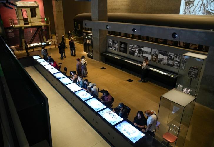 A guard tower from Angola Prison stand in the background at the National Museum of African American History and Culture. The
