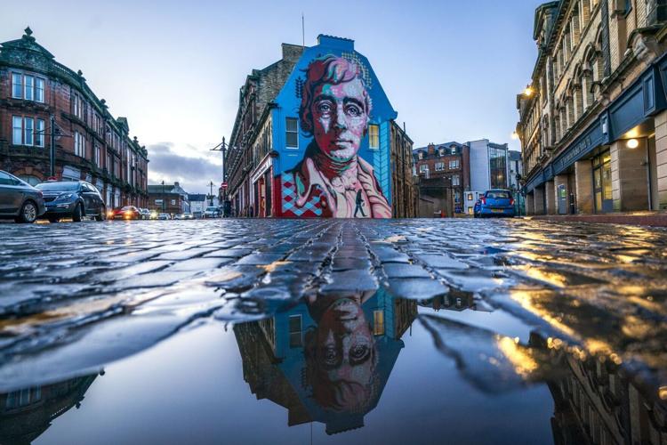 Kilmarnock does not only boast a castle but a local celebration of famed poet Robert Burns. Here, the Robert Burns Mural, created by artist Michael Corr on the the gable-end wall of the Robert Burns World Federation building in Kilmarnock, East Ayrshire...
