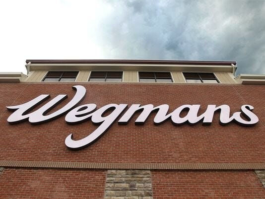 Wegmans sign looms over the entrance of the East Avenue store. (copy)