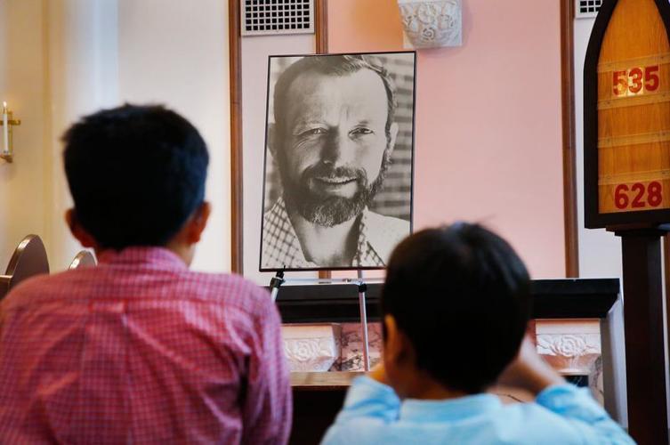 In this July 28, 2015, photo, a framed portrait of the Rev. Stanley Rother is placed near the altar during an Oklahoma City Mass commemorating the anniversary of Rother's death.