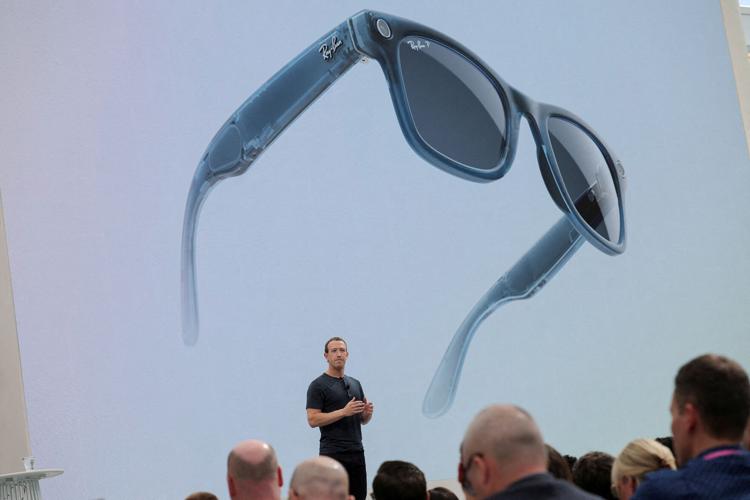 FILE PHOTO: A pair of Ray-Ban smart glasses appear on screen at an event in California