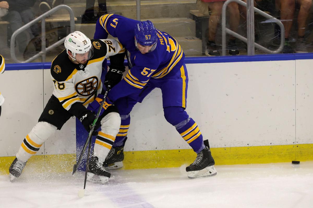 Sabres prospect left wing Brett Murray (57) gets tied up with Bruins prospect defenseman Andrew Peski (78)