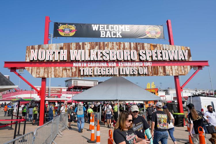 Fans stream into the entrance of North Wilkesboro Speedway for NASCAR All-Star Race weekend on May 21, 2023.