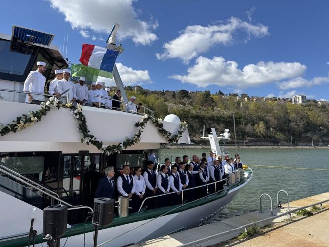 The Lumiere crew gather on deck for the riverboat's christening ceremony in late March.