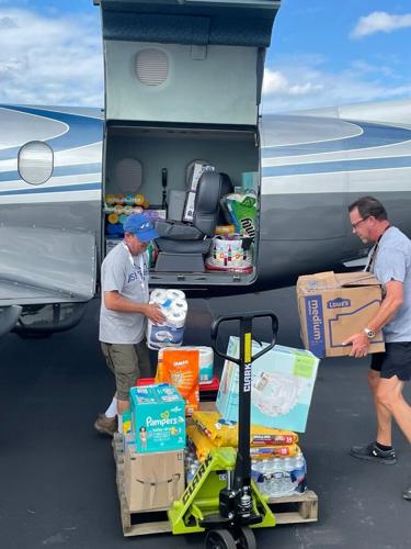 Volunteers loading a plane