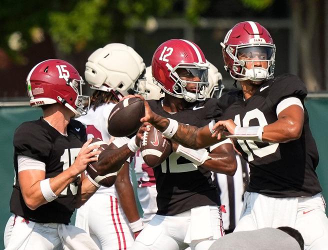 Alabama quarterbacks Austin Mack (10) and Keelon Russell (12) throw during practice in Tuscaloosa, Ala., on Aug. 19, 2025.