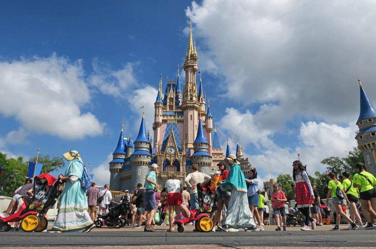 Guests walk past Cinderella Castle at the Magic Kingdom in Walt Disney World, Wednesday, April 2, 2025.