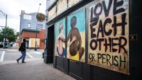 Greensboro downtown community bands together to preserve plywood murals