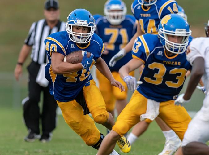 DuringNorth Carolina High School football action Friday night at Mt pleasant High School,Concord,North Carolina, The Tigers opened the 2019 season against the Jay M. Robinson Bulldogs..Anthony Eury(40) has a blocker in the name of Layton Honeycutt(33)