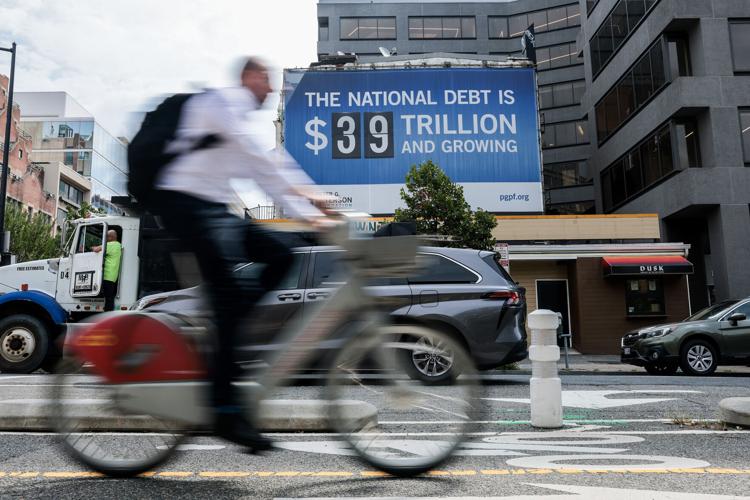 A sign displaying national debt hangs from a building in Foggy Bottom on Aug. 20, 2026, in Washington, D.C. Signs have been put up across the country made by the nonpartisan Peter G. Peterson Foundation. (copy)
