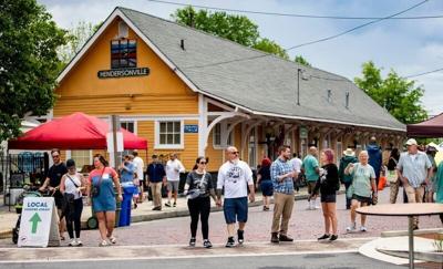 Hendersonville residents walk along Maple Street in downtown Hendersonville, May 3, 2025, during the Hendersonville Farmers Market Opening Day & 7th Avenue Street Fest.