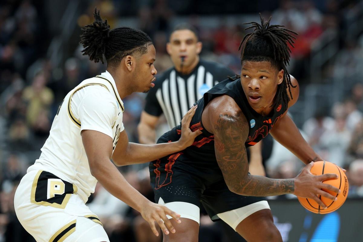 Shelton Henderson of the Miami Hurricanes dribbles against Gicarri Harris of the Purdue Boilermakers during the first half in the second round of the 2026 NCAA Men's Basketball Tournament at Enterprise Center on Sunday, March 22, 2026, in St Louis.