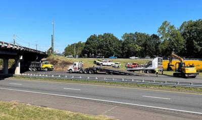 N.C. Highway Patrol, Orange County Sheriffs Office and Hillsborough Police were helping to direct traffic Wednesday morning, Aug. 14, 2022, at Interstate 85 and NC 86 in Hillsborough as the remains of a tractor-trailer were being loaded onto a truck fo...