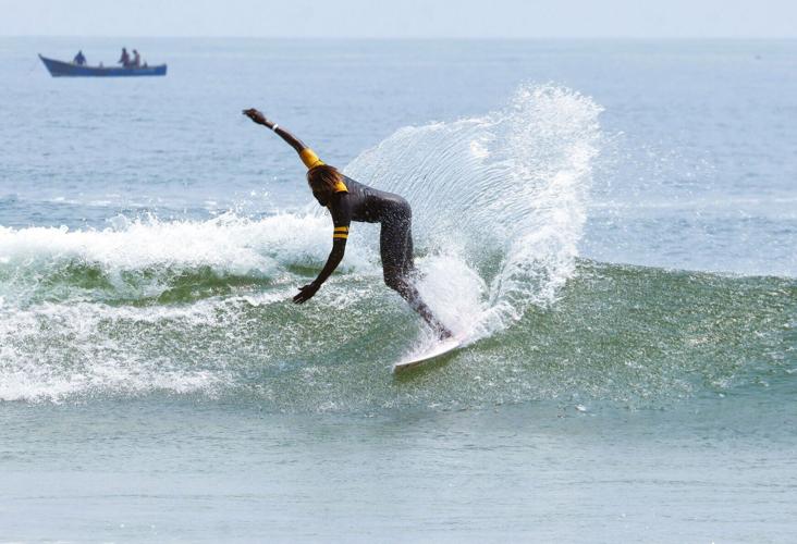 A surfer rides a wave here at Praia dos Surfistas in Cabo Ledo, around 75 miles south of Luanda.