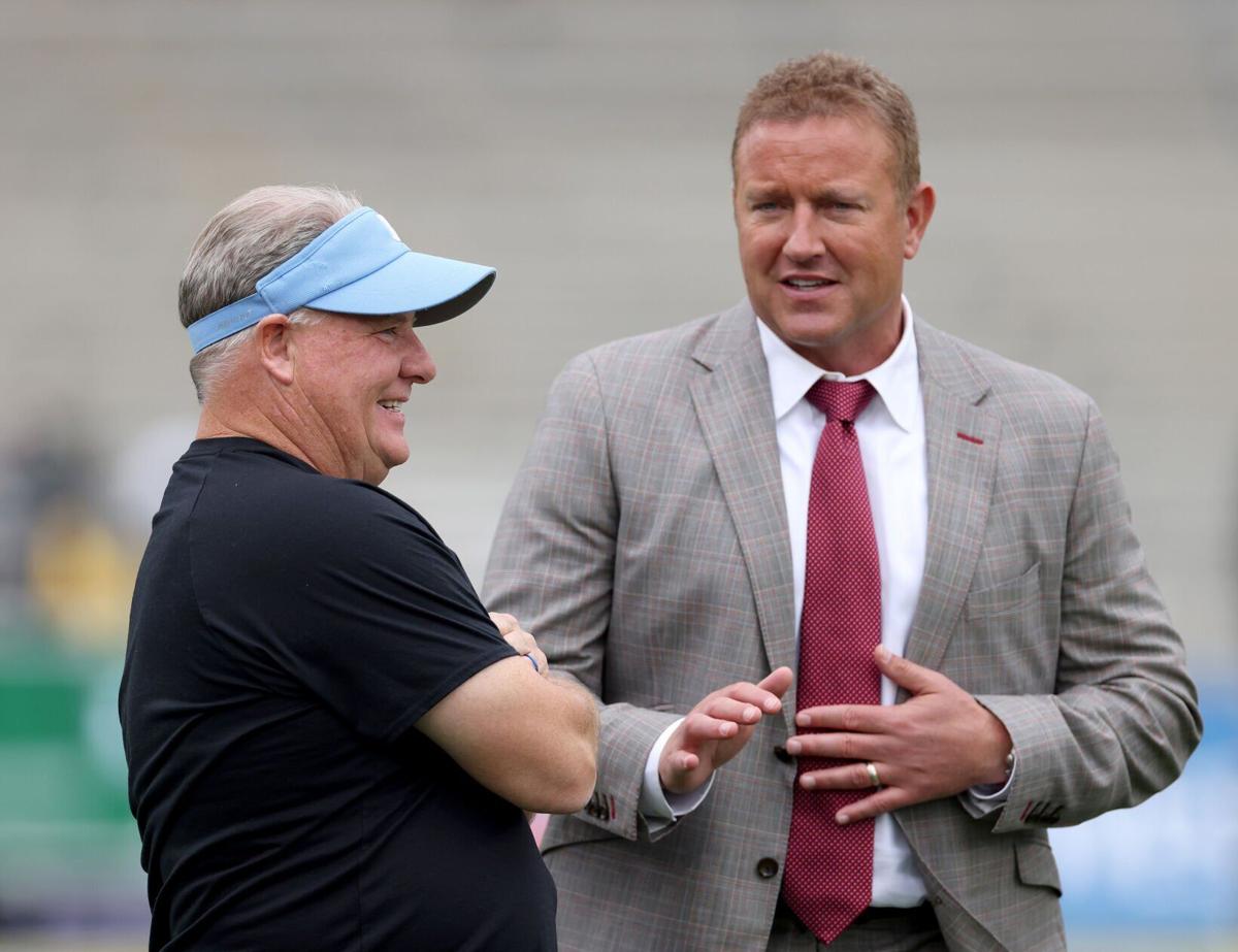 Head coach Chip Kelly of the UCLA Bruins talks with ESPN football analyst Kirk Herbstreit before a game against the Oregon Ducks at Rose Bowl on Oct. 23, 2021, in Pasadena, California.