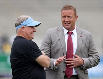 Head coach Chip Kelly of the UCLA Bruins talks with ESPN football analyst Kirk Herbstreit before a game against the Oregon Ducks at Rose Bowl on Oct. 23, 2021, in Pasadena, California.