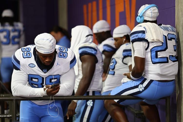 Sep 19, 2026; Clemson, South Carolina, USA;  University of North Carolina Tar Heels players wait during a lightning delay against Clemson Tigers at Memorial Stadium.  Mandatory Credit: Ashley Tumlin-Imagn Images