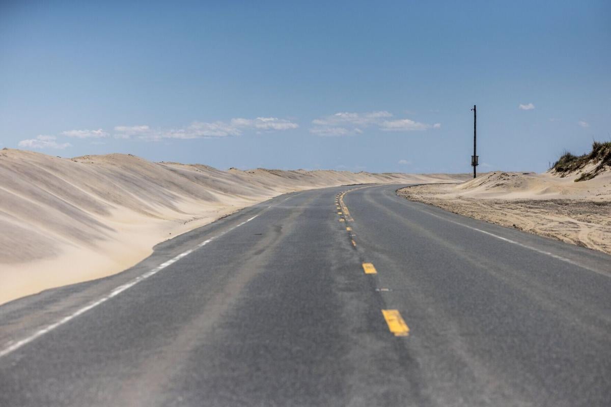 Sand dunes encroach on North Carolina’s Highway 12 on Pea Island in the Outer Banks on Friday, May 15, 2026.