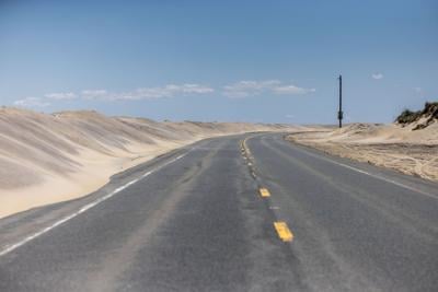 Sand dunes encroach on North Carolina’s Highway 12 on Pea Island in the Outer Banks on Friday, May 15, 2026.