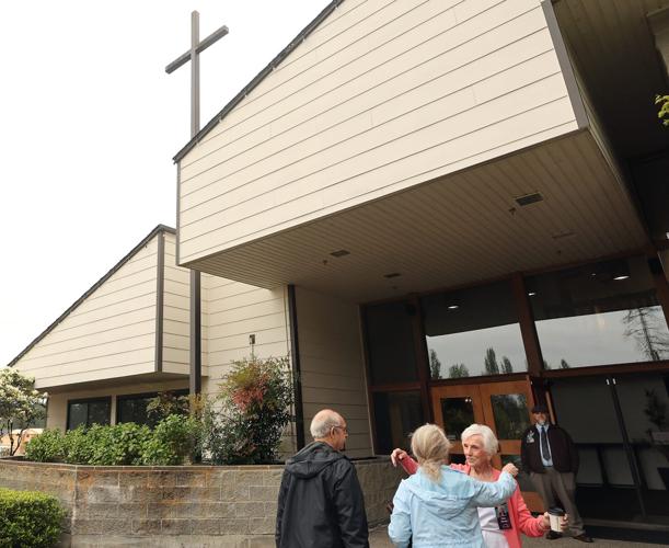 Helen Johnson, right, moves in to hug a fellow parishioner while greeting at the 8 a.m. service at Peninsula Bible Fellowship in Central Kitsap on May 10. PBF's attendance has increased about 10% in the past six years, part of a post-pandemic national tren