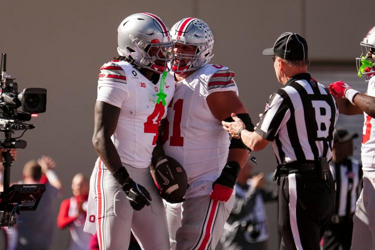 Ohio State wide receiver Jeremiah Smith (4) celebrates a touchdown with offensive lineman Luke Montgomery (51) during their game against Indiana at Memorial Stadium.