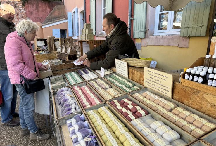 A market vendor in the colorful village of Roussillon, one of the non-river towns cruise passengers can visit by bus.