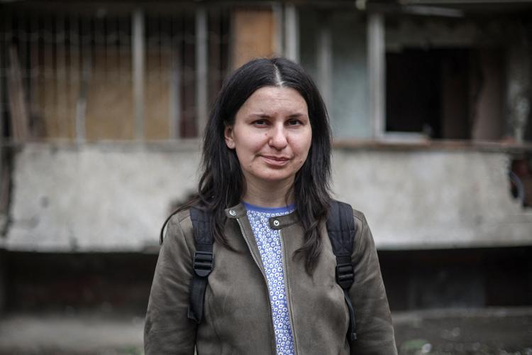 Resident, who survived in Russian attack, comes back to her damaged home