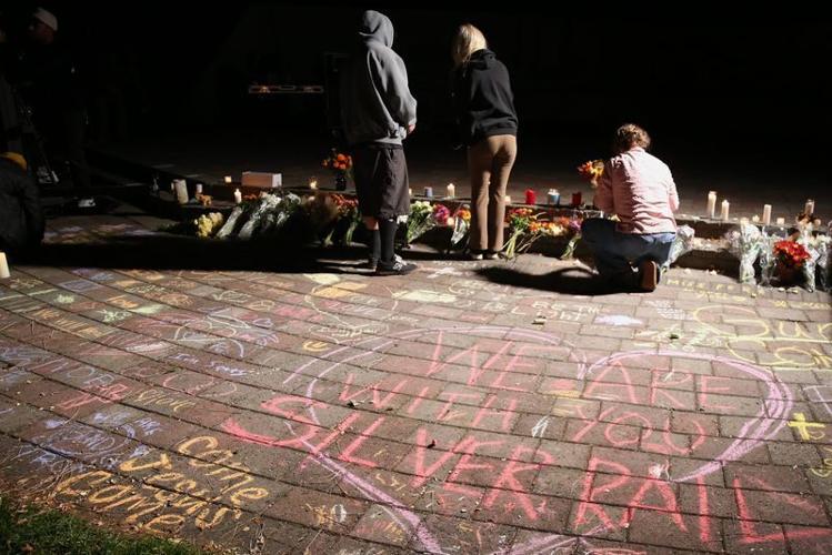 People take part in a candlelight vigil at Drake Park for victims of the Silver Rail Elementary School shooting in Bend on Oct. 15.