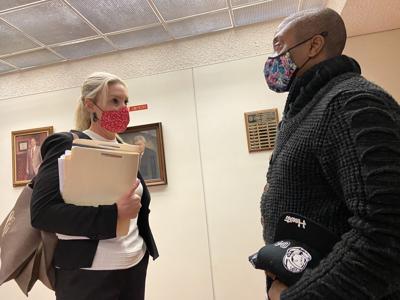 Ashley Cannon (left) speaks with her client, Jermaine Sanders, outside of the courtroom on Tuesday in Statesville.